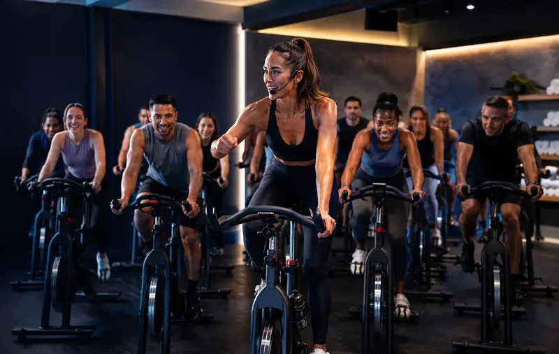 Indoor Cycling Instructor leading a group indoor cycling fitness class